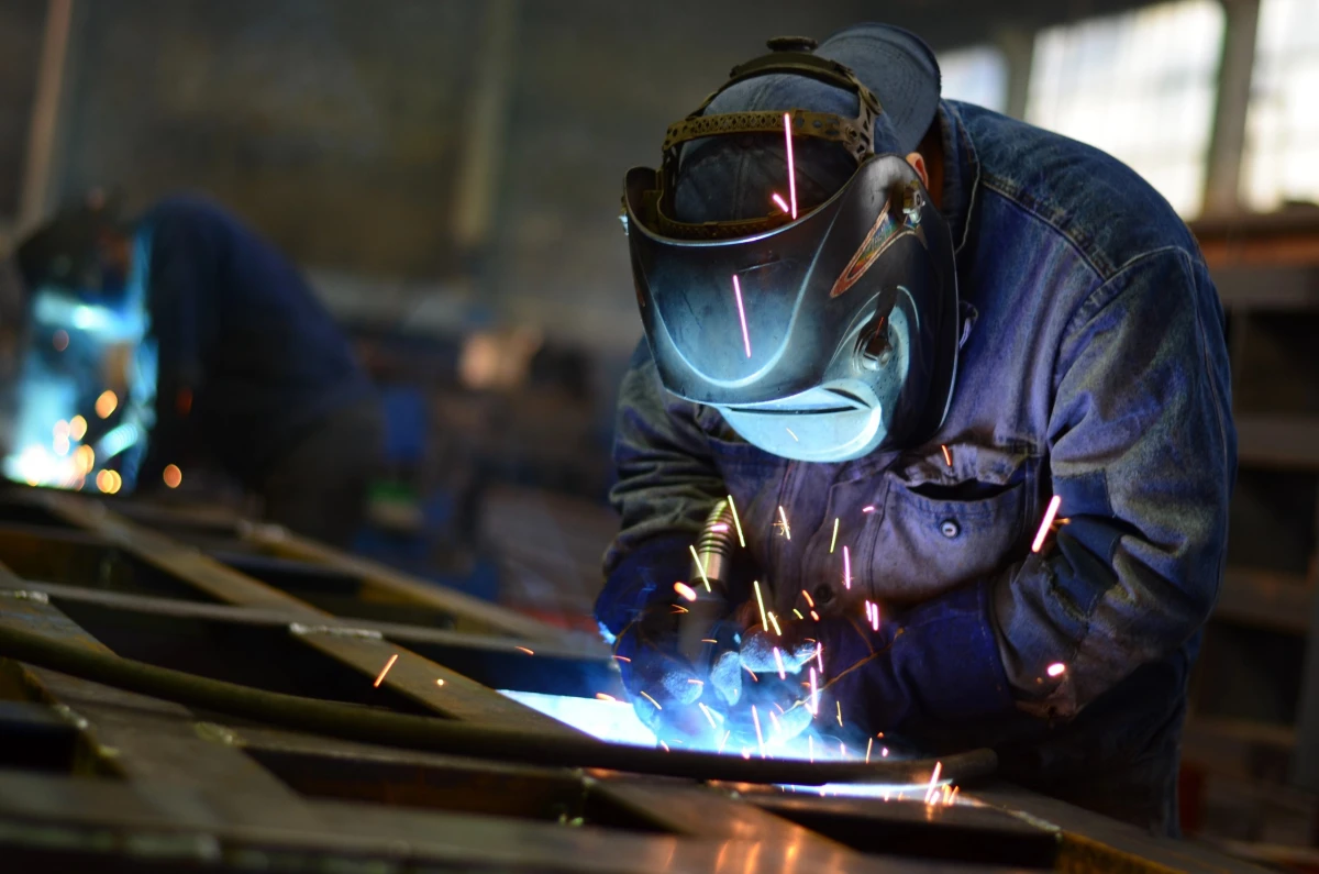 Welders working at the factory made metal